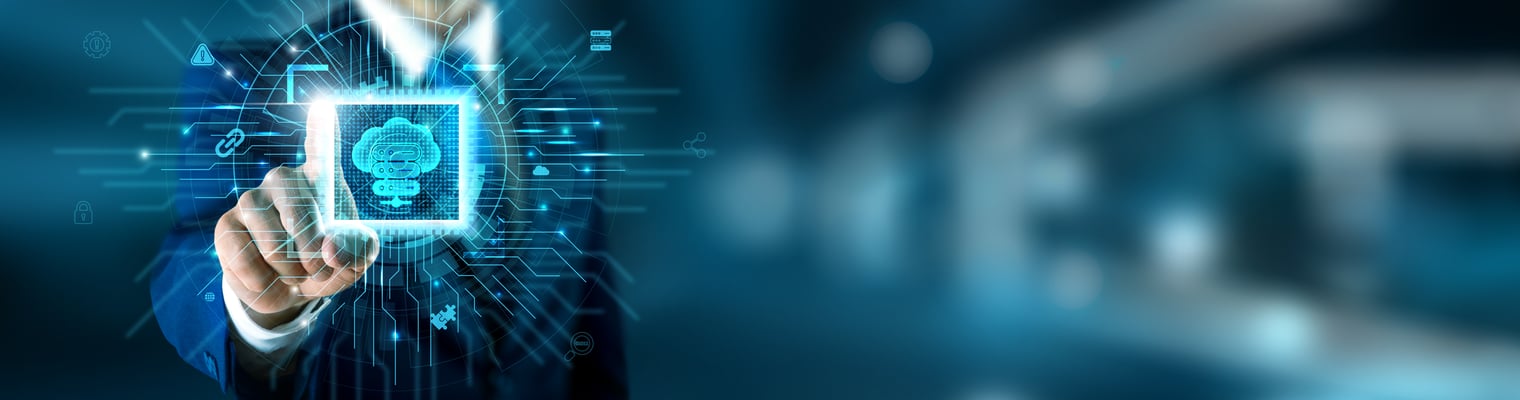 A imagem mostra uma cena de tecnologia e computação em nuvem com forte apelo corporativo. Em primeiro plano, uma mão humana estendida toca uma interface digital holográfica, como se estivesse interagindo com um painel virtual transparente. No centro desse painel há um ícone de nuvem estilizado, cercado por linhas, circuitos e símbolos tecnológicos que remetem a infraestrutura de TI, conectividade, dados e automação. Os elementos gráficos lembram fluxos de informação, integração entre sistemas e controle digital. O fundo é desfocado, em tons de azul e cinza, sugerindo um ambiente corporativo ou data center, o que reforça a ideia de soluções empresariais, cloud computing e gestão de infraestrutura. A iluminação e os efeitos visuais passam uma sensação de modernidade, segurança e controle tecnológico. No conjunto, a imagem comunica conceitos como gestão de cloud, painéis de controle, infraestrutura digital e interação humana com sistemas avançados, sendo bastante alinhada a temas de servidores, plataformas de gerenciamento e ambientes de TI corporativos.